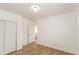 Simple bedroom with wood-look floors and an adjacent bathroom at 728 E Beecher St, Indianapolis, IN 46203