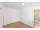Bedroom with wood-look floors and bathroom access at 728 E Beecher St, Indianapolis, IN 46203