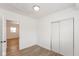 Simple bedroom with wood-look floors and access to another room at 728 E Beecher St, Indianapolis, IN 46203