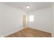 Simple bedroom with wood-look floors and access to a bathroom at 728 E Beecher St, Indianapolis, IN 46203