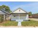 Charming yellow bungalow with light blue steps and walkway at 728 E Beecher St, Indianapolis, IN 46203