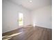Bright bonus room with wood-look floors and door to backyard at 168 Velvet Hat Rd, Danville, IN 46122