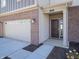 Brick home's front entry with a dark brown door and attached garage at 168 Velvet Hat Rd, Danville, IN 46122