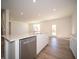 Open concept kitchen and living area with modern appliances and wood-look floors at 168 Velvet Hat Rd, Danville, IN 46122