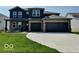 Two-story home with a brick and siding exterior, three-car garage, and manicured lawn at 140 Hobbs Dr, Whiteland, IN 46184