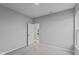 Simple bedroom with grey walls and carpet, leading to exterior at 4959 Amber Crest Dr, Brownsburg, IN 46112