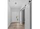 Spacious entryway with light gray walls, vinyl flooring, and barn door at 4959 Amber Crest Dr, Brownsburg, IN 46112