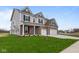 Two-story home with gray siding, three-car garage, and a well-manicured lawn at 4959 Amber Crest Dr, Brownsburg, IN 46112