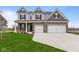 Two-story home with brick and siding, three-car garage, and landscaped lawn at 4959 Amber Crest Dr, Brownsburg, IN 46112