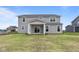 Gray two-story house with covered patio and grassy backyard at 4959 Amber Crest Dr, Brownsburg, IN 46112