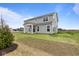 Gray two-story house with covered patio and grassy backyard at 4959 Amber Crest Dr, Brownsburg, IN 46112