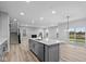 Open concept kitchen with gray cabinets, large island, and stainless steel appliances at 4959 Amber Crest Dr, Brownsburg, IN 46112
