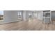 Open concept kitchen and dining area with island, gray cabinets, and vinyl plank flooring at 4959 Amber Crest Dr, Brownsburg, IN 46112