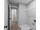 Laundry room with built-in shelving and vinyl flooring at 4959 Amber Crest Dr, Brownsburg, IN 46112