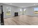 Bright living room with multiple windows, fireplace, and vinyl plank flooring at 4959 Amber Crest Dr, Brownsburg, IN 46112