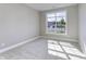 Well-lit bedroom with carpeted floor and a large window at 14999 Quinn Ln, Westfield, IN 46074