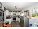 Bright kitchen with white cabinets, stainless steel appliances, and vinyl flooring at 941 N 500 W, Columbus, IN 47201