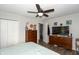 Main bedroom with large TV, ceiling fan, and ample closet space at 941 N 500 W, Columbus, IN 47201