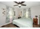 Spacious bedroom with a ceiling fan, light green bedding, and plenty of natural light at 941 N 500 W, Columbus, IN 47201