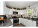 Modern kitchen with white cabinets and stainless steel appliances at 941 N 500 W, Columbus, IN 47201