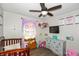 bedroom with unicorn decor, crib, and plenty of toys at 941 N 500 W, Columbus, IN 47201