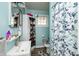Clean bathroom with light blue walls, a shower/tub combo and corner storage at 941 N 500 W, Columbus, IN 47201