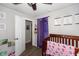 bedroom with crib, purple curtains, and cheerful wall art at 941 N 500 W, Columbus, IN 47201