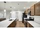 Open concept kitchen with island, stainless steel appliances and wood cabinets at 134 Maxim Ct, Cumberland, IN 46229