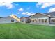 Community backyard with multiple homes and lush green grass at 134 Maxim Ct, Cumberland, IN 46229