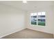 Bright bedroom with neutral walls and carpet, featuring a large window with a view at 134 Maxim Ct, Cumberland, IN 46229