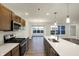 Open concept kitchen with island, stainless steel appliances, and wood cabinets at 134 Maxim Ct, Cumberland, IN 46229