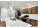 Modern kitchen with an island, stainless steel appliances, and wood cabinets at 134 Maxim Ct, Cumberland, IN 46229