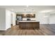 Modern kitchen featuring an island, stainless steel appliances, and wood cabinetry at 134 Maxim Ct, Cumberland, IN 46229