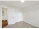Well-lit bedroom with carpet flooring, double doors to closet, and access to hallway at 134 Maxim Ct, Cumberland, IN 46229