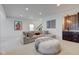 Finished basement features a cozy sectional sofa and a wet bar with stylish tile at 729 Greenford N Trl, Carmel, IN 46032