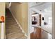 Beige carpeted staircase with view to kitchen and living room at 6275 Canak Dr, Avon, IN 46123