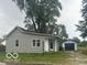 Ranch style home with gray siding and detached garage at 108 N Summit St, Summitville, IN 46070
