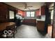 Kitchen with orange cabinets, black appliances, and tile floor at 108 N Summit St, Summitville, IN 46070