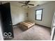Simple bedroom with a wooden frame bed and carpet flooring at 108 N Summit St, Summitville, IN 46070