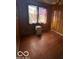 Simple bedroom with wood flooring and a window at 108 N Summit St, Summitville, IN 46070
