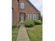 Brick home with a well-maintained lawn and walkway at 10870 Picket Fence Pl, Fishers, IN 46037