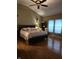 Large main bedroom with hardwood floors and ceiling fan at 10870 Picket Fence Pl, Fishers, IN 46037