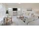 Spacious living room with neutral colored sofas and a large TV at 3923 Windstar Way, Columbus, IN 47203