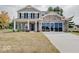 Two story brick home with gray siding and three car garage at 3923 Windstar Way, Columbus, IN 47203