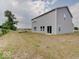 Gray house exterior with large backyard at 3923 Windstar Way, Columbus, IN 47203