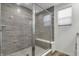 Modern shower with gray tile, glass enclosure, and built-in seat at 14210 Tenbury Way, Fishers, IN 46037