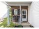 Cozy front porch with brick facade and seating at 4620 Whitham Ln, Indianapolis, IN 46237