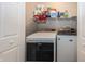 Laundry room with washer, dryer, and shelving at 4620 Whitham Ln, Indianapolis, IN 46237