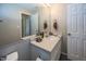 Clean bathroom with single vanity and mirror at 4620 Whitham Ln, Indianapolis, IN 46237