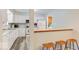 White kitchen with breakfast bar and view into dining area at 7932 Eagle Valley Pass, Indianapolis, IN 46214